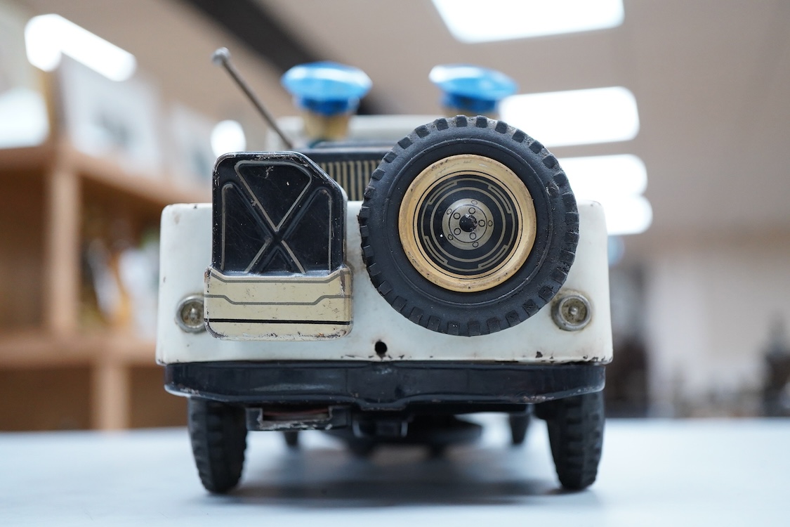A 1960s Japanese T.N. Nomura battery powered tinplate and plastic Police Department Jeep, impressed manufacturer’s logo and ‘Made in Japan’ to the base